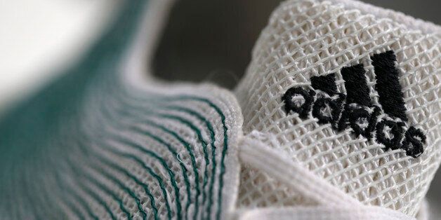 An Adidas logo is pictured on a shoe made from recycled ocean plastic before the company's annual news conference in the northern Bavarian town of Herzogenaurach, near Nuremberg March 3, 2016. German sportswear company Adidas expects sales and net profit to keep rising fast in 2016, helped by aggressive marketing and big events like the European soccer championships and the Rio Olympics. REUTERS/Michaela Rehle