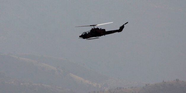 Turkish Cobra attack helicopters hovers over mountains near the Turkey-Iraq border, in the province of Sirmak, southeast Turkey, Monday, Oct. 29, 2007. Turkish military continues pursuing Kurdish separatist rebels with land and air operations. (AP Photo/Darko Bandic)