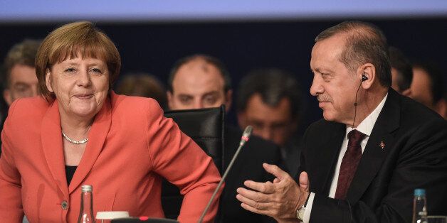 German Chancellor Angela Merkel, is applauded by Turkey's President Recep Tayyip Erdogan, following her speech during a roundtable meeting on