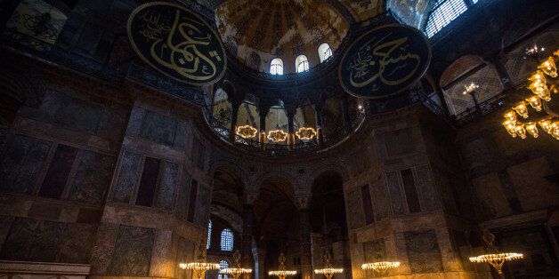 ISTANBUL, TURKEY - FEBRUARY 11: A tourist takes a photograph of the interior of the Hagia Sophia Museum on February 11, 2016 in Istanbul, Turkey. The Hagia Sophia (Ayasofya) Museum is one of the most visited tourist attractions in Turkey, with more than 3 million visitors per year. Constructed in 537 the museum originally served as an Orthodox Cathedral, later a Roman Catholic church and was converted into a mosque when Constantinople was conquered by the Ottoman Turks in 1453. In 1935 it was opened as a museum by the Republic of Turkey. The museum is currently undergoing restoration on various parts of the interior. (Photo by Chris McGrath/Getty Images)