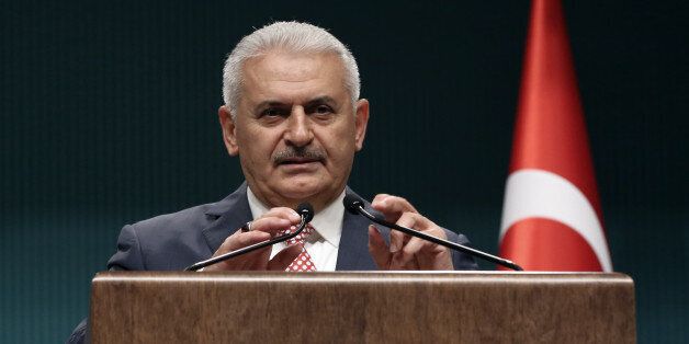 Binali Yildirim, who replaces the outgoing prime minister, Ahmet Davutoglu, announce his Cabinet after a meeting with President Recep Tayyip Erdogan in Ankara, Turkey, Tuesday, May 24, 2016. Erdogan has approved a new government formed by his trusted ally who has pledged to push through constitutional reforms that would expand the powers of the presidency.(AP Photo/Burhan Ozbilici)