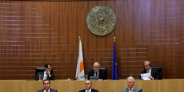 CYPRUS - 2015/07/17: The European Commission President Jean- Claude Juncker (right up) sitting in the Cypriot Parliament in Nicosia. The President of Cyprus (left up) Nicos Anastasiadis and the President of the Parliament Yiannakis Omirou (center up) He made an impassioned plea to Cypriot politicians on Friday to go for a solution and not to leave it to the next generation, as he addressed parliament in Nicosia. (Photo by Yiorgos Doukanaris/Pacific Press/LightRocket via Getty Images)
