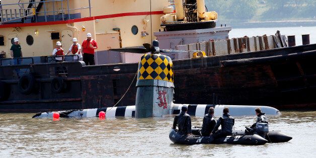 Officials remove a plane out of the Hudson River a day after it crashed, Saturday, May 28, 2016, in North Bergen, N.J. The World War II vintage P-47 Thunderbolt aircraft crashed into the river Friday, May 27
