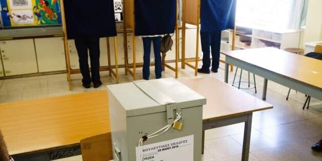 Cypriots stand inside voting booths before voting in the parliamentary elections at a polling station in Nicosia on May 22, 2016. Cyprus went to the polls with leaders appealing to voters to turnout despite widespread disillusion with lawmakers after a prolonged downturn triggered by a eurozone bailout. President Nicos Anastasiades, whose right-wing government negotiated the 2013 bailout by international creditors and has claimed credit for the island's subsequent recovery, warned those tempted to abstain that they risked losing their right to a say. / AFP / Iakovos Hatzistavrou (Photo credit should read IAKOVOS HATZISTAVROU/AFP/Getty Images)