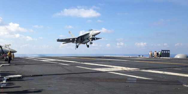 FILE - In this Friday, April 15, 2016 file photo, an FA-18 jet fighter lands on the USS John C. Stennis aircraft carrier in the South China Sea while U.S. Defense Secretary Ash Carter visited the aircraft carrier during a trip to the region. The U.S. has upset China by sending The USS William P. Lawrence guided missile destroyer on Wednesday, May 11, close to the largest man-made island in disputed South China Sea waters. Beijing responded by saying it will step up its own patrols. The likely election of Rodrigo Duterte in the new Philippines could undermine his predecessorâs policy that was unusually hostile to Beijing and relied on U.S. military backing. (AP Photo/Lolita C. Baldor, File)
