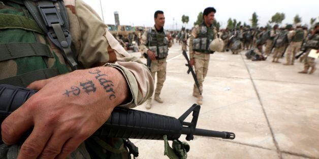 Kurdish Peshmerga fighters take part in a graduation ceremony on May 5, 2016 at the Kurdistan Training Coordination Center (KTTC) of Arbil, the capital of the autonomous Kurdish region of northern Iraq.The KTTC is a joint effort of the Dutch, Italian, British and German governments which aims to unify the military assistance of these countries. / AFP / SAFIN HAMED (Photo credit should read SAFIN HAMED/AFP/Getty Images)