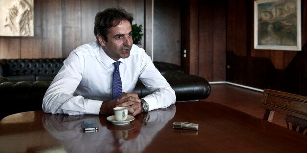 Greece's Administrative Reform minister Kyriakos Mitsotakis speaks during an interview with Reuters in Athens July 31, 2013. Mitsotakis, an ex-banker and son of a former prime minister, says his ambitions go beyond fulfilling numerical targets set under Greece's international bailout deal to keep funds flowing from the European Union and IMF. Reform, he says, is also about making Greek public employees accept what is standard practice elsewhere in the world - like working the hours they are paid for, or losing their salary if they go to jail. Picture taken July 31, 2013. REUTERS/Yorgos Karahalis (GREECE - Tags: POLITICS BUSINESS)
