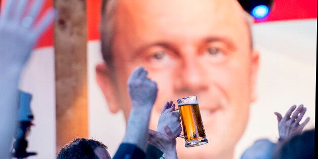 Supporters of Austrian Freedom Party (FPOe) presidential candidate Norbert Hofer (R) party at the Prater Alm Bar, during the Austrian presidential elections run-off in Vienna, Austria, on May 22, 2016. / AFP / JOE KLAMAR (Photo credit should read JOE KLAMAR/AFP/Getty Images)