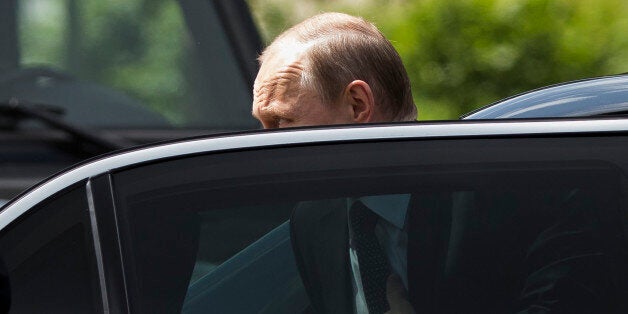 Russian President Vladimir Putin gets off a car as he arrives to take part in a wreath laying ceremony at the Tomb of the Unknown Soldier outside Moscow's Kremlin Wall, in Moscow, Russia, Monday, June 22, 2015, to mark the 74th anniversary of the Nazi invasion of the Soviet Union. (AP Photo/Alexander Zemlianichenko)