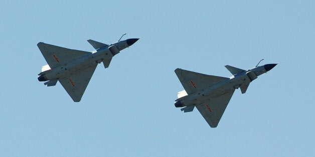 Chinese J-10 fighter jets fly on display over the Yangcun Air Force base of the People's Liberation Army Air Force in Tianjin, home of the 24th Fighter Division, southeast of Beijing on April 13, 2010. The base is home to the August 1st (Bayi) Aerobatic Team of the PLAAF, named after the founding of the PLA on August 1, 1927. The Aerobatics team upgraded their jets to the J-10 multirole fighter in May 2009 and military attaches from various countries as well as foreign journalists were invited to the base for the airshow. AFP PHOTO/ Frederic J. BROWN (Photo credit should read FREDERIC J. BROWN/AFP/Getty Images)