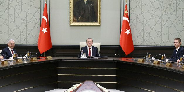 Turkish President Tayyip Erdogan, flanked by Prime Minister Binali Yildirim (L) and Deputy Prime Minister Nurettin Canikli (R), chairs the first cabinet meeting of the new government at the Presidential Palace in Ankara, Turkey, May 25, 2016. Yasin Bulbul/Presidential Palace/Handout via REUTERS ATTENTION EDITORS - THIS PICTURE WAS PROVIDED BY A THIRD PARTY. FOR EDITORIAL USE ONLY. NO RESALES. NO ARCHIVE.