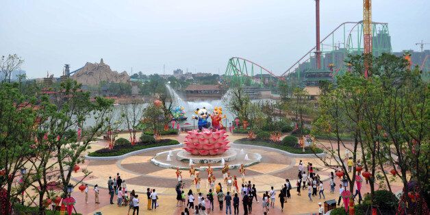 People visit the newly open theme park 'Wanda City' in Nanchang, east China's Jiangxi province on May 28, 2016. The Chinese conglomerate Wanda on May 28 opened its first theme park, with its billionaire boss declaring war on Disney weeks before the American entertainment giant launches a similar attraction in Shanghai. / AFP / STR / China OUT (Photo credit should read STR/AFP/Getty Images)