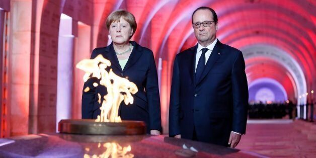 French President Francois Hollande (R) and German Chancellor Angela Merkel (L) pay their respects in front of the Eternal Flame in the Douaumont Ossuary (Ossuaire de Douaumont), northeastern France, on May 29, 2016, during a remembrance ceremony to mark the centenary of the battle of Verdun.The battle of Verdun, in 1916, was one of the bloodiest episodes of World War I. The offensive which lasted 300 days claimed more than 300,000 lives. / AFP / POOL / MATHIEU CUGNOT (Photo credit should read MATHIEU CUGNOT/AFP/Getty Images)