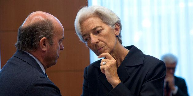 Managing Director of the International Monetary Fund Christine Lagarde, right, speaks with Spanish Economy Minister Luis de Guindos during a meeting of eurogroup finance ministers in Brussels on Saturday, June 27, 2015. Anxiety over Greece's future swelled on Saturday after Prime Minister Alexis Tsipras' call to have the people vote on a proposed bailout deal. (AP Photo/Virginia Mayo)