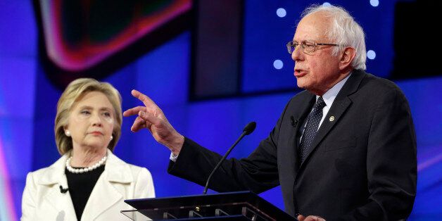 Democratic presidential candidate Sen. Bernie Sanders, I-V.t, right, speaks as Hillary Clinton listens during the CNN Democratic Presidential Primary Debate at the Brooklyn Navy Yard on Thursday, April 14, 2016 in New York. (AP Photo/Seth Wenig)