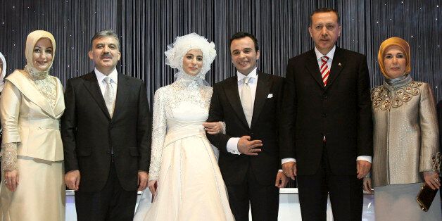 Turkish President Abdullah Gul, second from left, and his wife Hayrunnisa Gul, left, accompanied by Turkish Prime Minister Recep Tayyip Erdogan, second from right, and his wife Emine Erdogan, right, pose with Gul's newly married daughter, Kubra Gul Sarimermer, third from left, and her groom Mehmet Sarimermer, third from right, during a wedding ceremony in Istanbul, Turkey, Sunday, Oct. 14, 2007. (AP Photo/Kayhan Ozer, Pool)