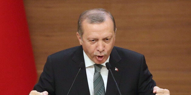 Turkish President Tayyip Erdogan gestures as he speaks during a meeting with mukhtars or local village and town leaders at the Presidential Palace in Ankara, on May 4, 2016. / AFP / ADEM ALTAN (Photo credit should read ADEM ALTAN/AFP/Getty Images)