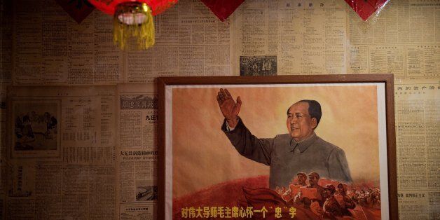 A poster showing the late Chinese chairman Mao Zedong hangs on a wall inside a restaurant in Beijing on May 13, 2016.Fifty years after the Cultural Revolution spread bloodshed and turmoil across China, the Communist-ruled country is driving firmly down the capitalist road, but Mao Zedong's legacy remains -- like the embalmed leader himself -- far from buried. / AFP / NICOLAS ASFOURI (Photo credit should read NICOLAS ASFOURI/AFP/Getty Images)