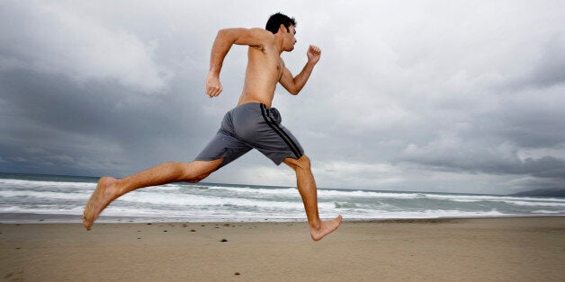 Young man running on beach