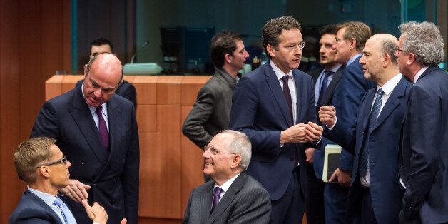 Germany's Finance Minister Wolfgang Schauble, center, talks with Spain's Finance Minister Luis de Guindos, 2nd left, and Finland's Finance Minister Alexander Stubb, left, while Eurogroup President Jeroen Dijsselbloem, 3rd right, talks with EU Commissioner for Economic and Financial Affairs, Taxation and Customs Pierre Moscovici, 2nd right, and Luxembourg's Finance Minister Pierre Gramegna during the Eurogroup finance ministers meeting at the EU Council building in Brussels on Thursday, Feb. 11, 2016. (AP Photo/Geert Vanden Wijngaert)