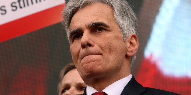 Austria's Chancellor Werner Faymann listens to a speech during the traditional May Day celebrations of the Austrian Social Democrats, SPOE, in Vienna, Austria, Sunday, May 1, 2016. Every year around hundred thousand citizens participate at the event. (AP Photo/Ronald Zak)