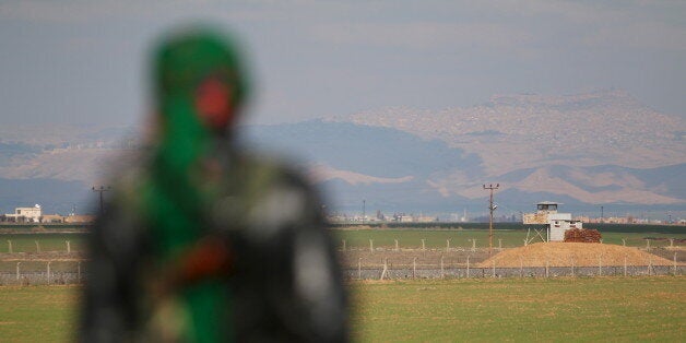 A Kurdish member of the Self-Defense Forces stands near the Syrian-Turkish border in the Syrian city of al-Derbasiyah during a protest against the operations launched in Turkey by government security forces against the Kurds, February 9, 2016. REUTERS/Rodi Said