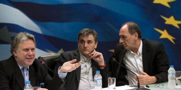 Greek Labour Minister George Katrougalos, left, speaks next to Greek Finance Minister Euclid Tsakalotos, center, and Economy Minister George Stathakis during a news conference in Athens, on Tuesday, April 12, 2016. Greece and bailout creditors have suspended talks on the countryâs austerity program until next week, but Athens promised to submit a major new round of cost-cutting reforms to be voted by parliament by the end of the month.(AP Photo/Petros Giannakouris)