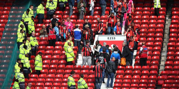 MANCHESTER, ENGLAND - MAY 15: Fans are evacuated from the ground as the match is abandoned ahead of the Barclays Premier League match between Manchester United and AFC Bournemouth at Old Trafford on May 15, 2016 in Manchester, England. (Photo by Alex Livesey/Getty Images)