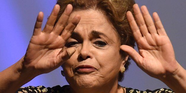 Brazilian President Dilma Rousseff gestures during the opening ceremony of the 4th National Policy Conference on Women in Brasilia on May 10, 2016.Rousseff vowed Tuesday to serve out her full term, on the eve of a Senate vote on opening an impeachment trial that could mark her last day in office. Rousseff is accused of using accounting tricks and unauthorized state loans to boost public spending during her 2014 re-election campaign. She argues the same accounting techniques were used regularly by previous governments and fall far short of an impeachable offense. / AFP / EVARISTO SA (Photo credit should read EVARISTO SA/AFP/Getty Images)