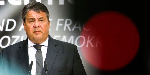 In this photo taken with a control light of a television camera in front, German Social Democratic Party, SPD, chairman and Germany's Vice Chancellor Sigmar Gabriel delivers a speech at a party congress in Berlin, Germany, Monday, May 9, 2016. (AP Photo/Markus Schreiber)