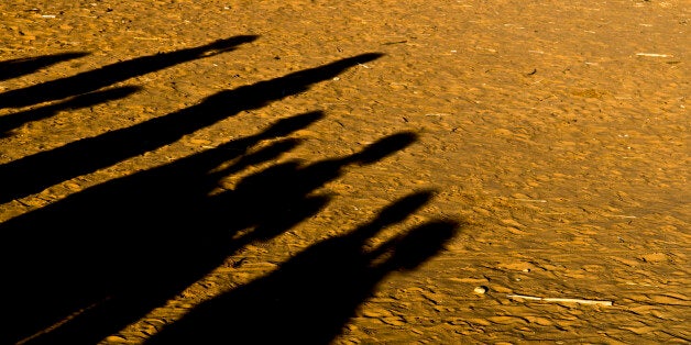 Djabal refugees camp - shadows of some sudanese people gathered in the camp.