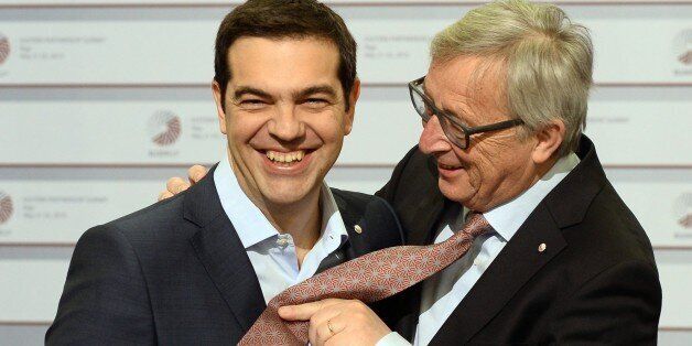 Greek Prime Minister Alexis Tsipras (L) and President of the European Commission Jean-Claude Juncker joke about a tie on the second day of the fourth European Union (EU) eastern Partnership Summit in Riga, on May 22, 2015 as Latvia holds the rotating presidency of the EU Council. EU leaders and their counterparts from Ukraine and five ex-Soviet states hold a summit focused on bolstering their ties, an initiative that has been undermined by Russia's intervention in Ukraine. AFP PHOTO / JANEK SKARZYNSKI (Photo credit should read JANEK SKARZYNSKI/AFP/Getty Images)