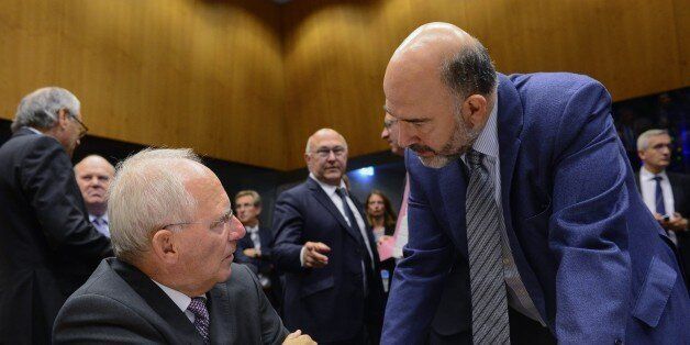 German Finance Minister Wolfgan Schaeuble (L) talks with EU Commissioner of Economic and Financial Affairs, Taxation and Customs Pierre Moscovici (R) during an Eurogroup meeting on October 05, 2015 in Luxembourg. AFP PHOTO/ JOHN THYS (Photo credit should read JOHN THYS/AFP/Getty Images)