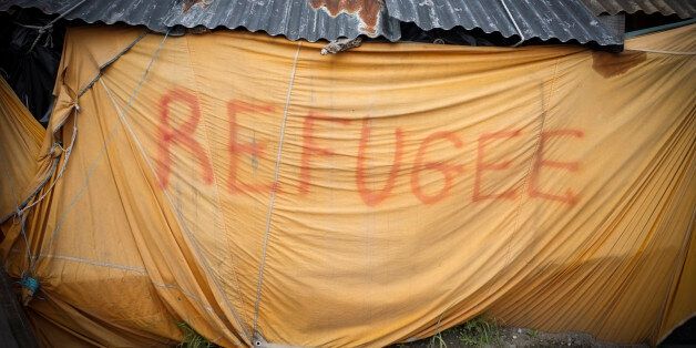 A makeshift tent with the word 'refugee' seen in the The Jungle Calais. June 2015.