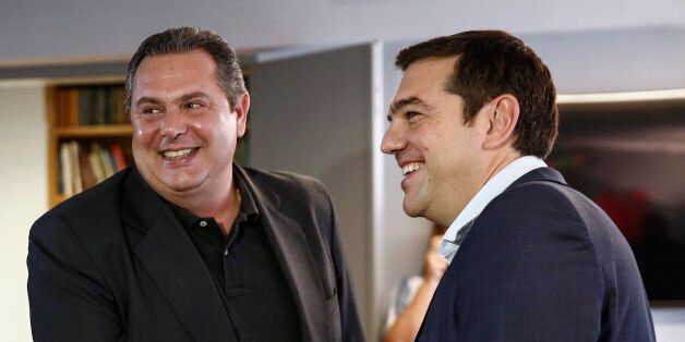 Alexis Tsipras, Greece's incoming prime minister, right, and Panos Kammenos, leader of the Independent Greeks Party, react while shaking hands during a meeting at his office in Athens, Greece, on Monday, Sept. 21, 2015. With Syriza set to fall short of a majority in the 300-seat parliament, Tsipras, 41, will enter negotiations to build a viable government with the same coalition partner as before, scotching expectations he might do a deal with a more moderate party. Photographer: Yorgos Karahalis/Bloomberg via Getty Images