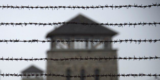 TO GO WITH AFP STORY BY NINA LAMPARSKI A barbed wire fence is pictured at the former Nazi concentration camp Mauthausen, northern Austria on April 28, 2015. AFP PHOTO / JOE KLAMAR (Photo credit should read JOE KLAMAR/AFP/Getty Images)