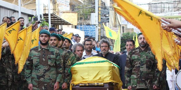 Adnan (C-L) and Hassan Badreddine (C-R), brothers of slain top Hezbollah commander Mustafa Badreddine who was killed in an attack in Syria, mourn next to his casket during the funeral in the Ghobeiry neighbourhood of southern Beirut on May 13, 2016.Hezbollah announced that Badreddine had been killed in an attack in Syria where the Shiite militant group has deployed thousands of fighters in support of the Damascus regime. The group said it was still investigating the cause of the blast near Damascus airport but it did not immediately point the finger at Israel as it did when the commander's predecessor was assassinated in the Syrian capital in 2008. / AFP / ANWAR AMRO (Photo credit should read ANWAR AMRO/AFP/Getty Images)