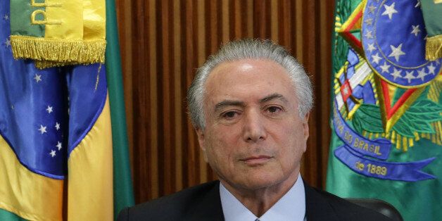 Brazil's acting President Michel Temer holds his first cabinet meeting , at the Planalto presidential palace in Brasilia, Brazil, Friday, May 13, 2016. Temer pledged Thursday to jumpstart the stalled economy and push ahead with a sprawling corruption investigation that has already ensnared top leaders of his own party and even implicated Temer himself. (AP Photo/Eraldo Peres)