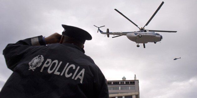 Police helicopters fly overhead as they patrol around the Elbasan Arena stadium prior the Euro 2016 Group I qualifying football match between Albania and Serbia in Elbasan on October 8, 2015. AFP PHOTO / NIKOLAY DOYCHINOV (Photo credit should read NIKOLAY DOYCHINOV/AFP/Getty Images)