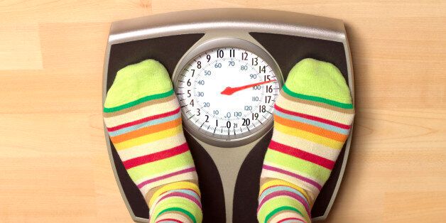 Overweight woman on bathroom scales