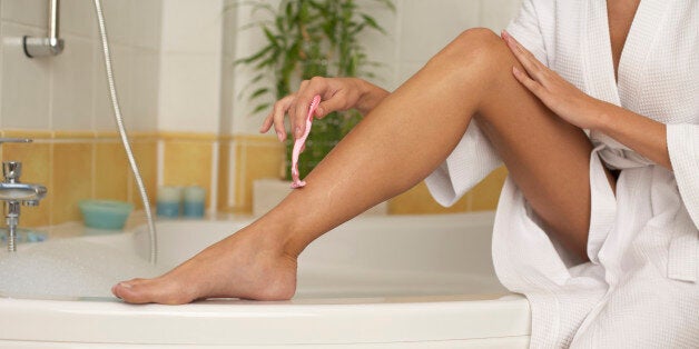 Woman shaving her legs