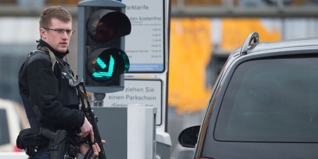 An armed policeman secures the access to the terminal area of the Frankfurt Airport, on March 22, 2016, in Frankfurt, western Germany.The increased security comes in the wake of the explosions in Brussels, that, according to several media, have claimed more lives. / AFP / DPA / Boris Roessler / Germany OUT (Photo credit should read BORIS ROESSLER/AFP/Getty Images)