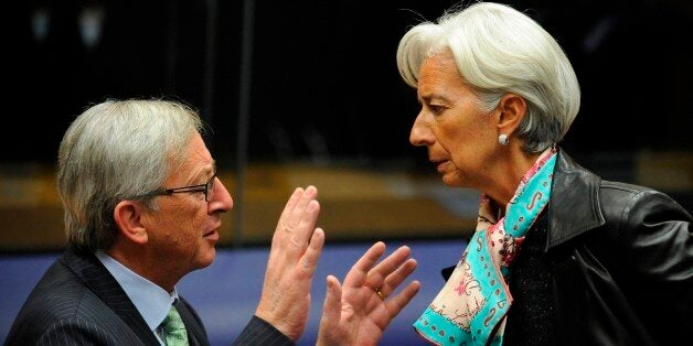 Luxembourg Prime Minister and President of the Eurogroup Council Jean-Claude Juncker (L) speaks with International Monetary Fund (IMF) chief Christine Lagarde on October 8, 2012 before a Eurogroup Council meeting in Luxembourg. AFP PHOTO/JOHN THYS (Photo credit should read JOHN THYS/AFP/GettyImages)