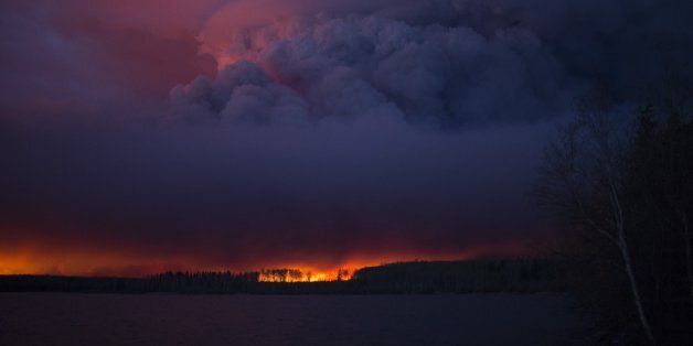 A massive wildfire, which caused a mandatory evacuation, rages south of Fort McMurray near Anzac, Alberta, Canada May 4, 2016. . Chris Schwarz/Government of Alberta/Handout via REUTERS ATTENTION EDITORS - THIS IMAGE WAS PROVIDED BY A THIRD PARTY. EDITORIAL USE ONLY. FOR EDITORIAL USE ONLY. NOT FOR SALE FOR MARKETING OR ADVERTISING CAMPAIGNS. THIS IMAGE HAS BEEN SUPPLIED BY A THIRD PARTY. IT IS DISTRIBUTED, EXACTLY AS RECEIVED BY REUTERS, AS A SERVICE TO CLIENTS