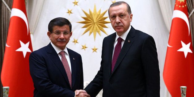 Turkey's Prime Minister Ahmet Davutoglu left, and President Recep Tayyip Erdogan shake hands before a meeting in Ankara, Turkey, Tuesday, Nov. 17, 2015. Erdogan has re-appointed Davutoglu to form a new government after his party's victory in elections on Nov.1.(Presidential Press Service/Pool Photo via AP)