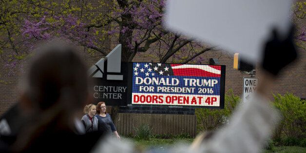 Demonstrators chant across the street from the venue of a campaign event for Donald Trump, president and chief executive of Trump Organization Inc. and 2016 Republican presidential candidate, at Century Center in South Bend, Indiana, U.S., on Monday, May 2, 2016. Trump doubled down on his claim that Hillary Clinton is using the 'woman's card' to win the Democratic nomination for president, saying she wouldn't be in the race if she were a man. Photographer: Daniel Acker/Bloomberg via Getty Images