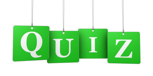 Quiz word and sign on green hanged label tags isolated on white background.