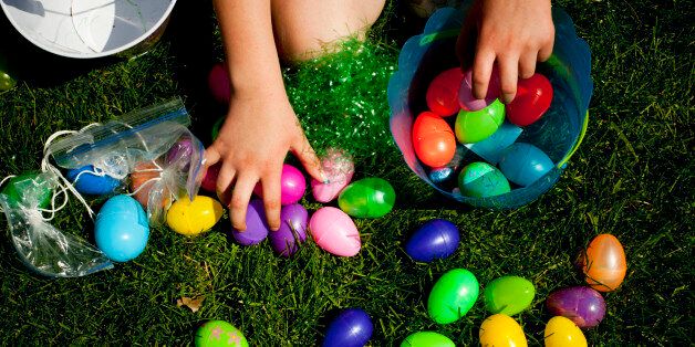 A child reaches for Easter eggs in the grass on a farm in Iowa.