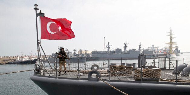 A Turkish marine serviceman stands on the deck of a Turkish navy TCG Turgutreis vessel in the Black Sea port of Constanta, Romania, Sunday, March 15, 2015. The ship will take part in NATO sea military exercises in the Black Sea region involving ships USS Vicksburg, as well as a German auxiliary ship and frigates from Canada, Turkey, Italy and Romania.(AP Photo/Vadim Ghirda)