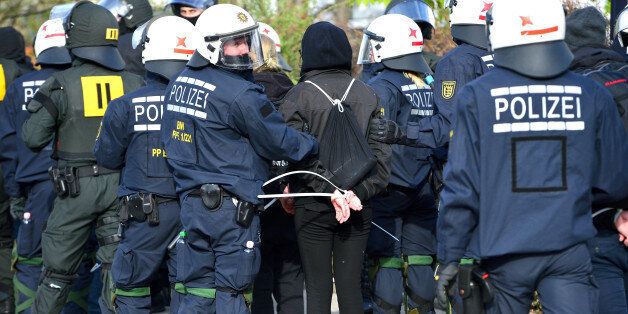 STUTTGART, GERMANY - APRIL 30: Police officers take anti-AfD-protesters into custody near the AfD (Alternative fuer Deutschland) party's federal congress at the Stuttgart Congress Centre ICS on April 30, 2016 in Stuttgart, Germany. The AfD, a relative newcomer to the German political landscape, has emerged from Euro-sceptic conservatism towards a more right-wing leaning appeal based in large part on opposition to Germany's generous refugees and migrants policy. Since winning seats in March elections in three German state parliaments the party has sharpened its tone, calling for a ban on minarets and claiming that Islam does not belong in Germany. (Photo by Thomas Lohnes/Getty Images)